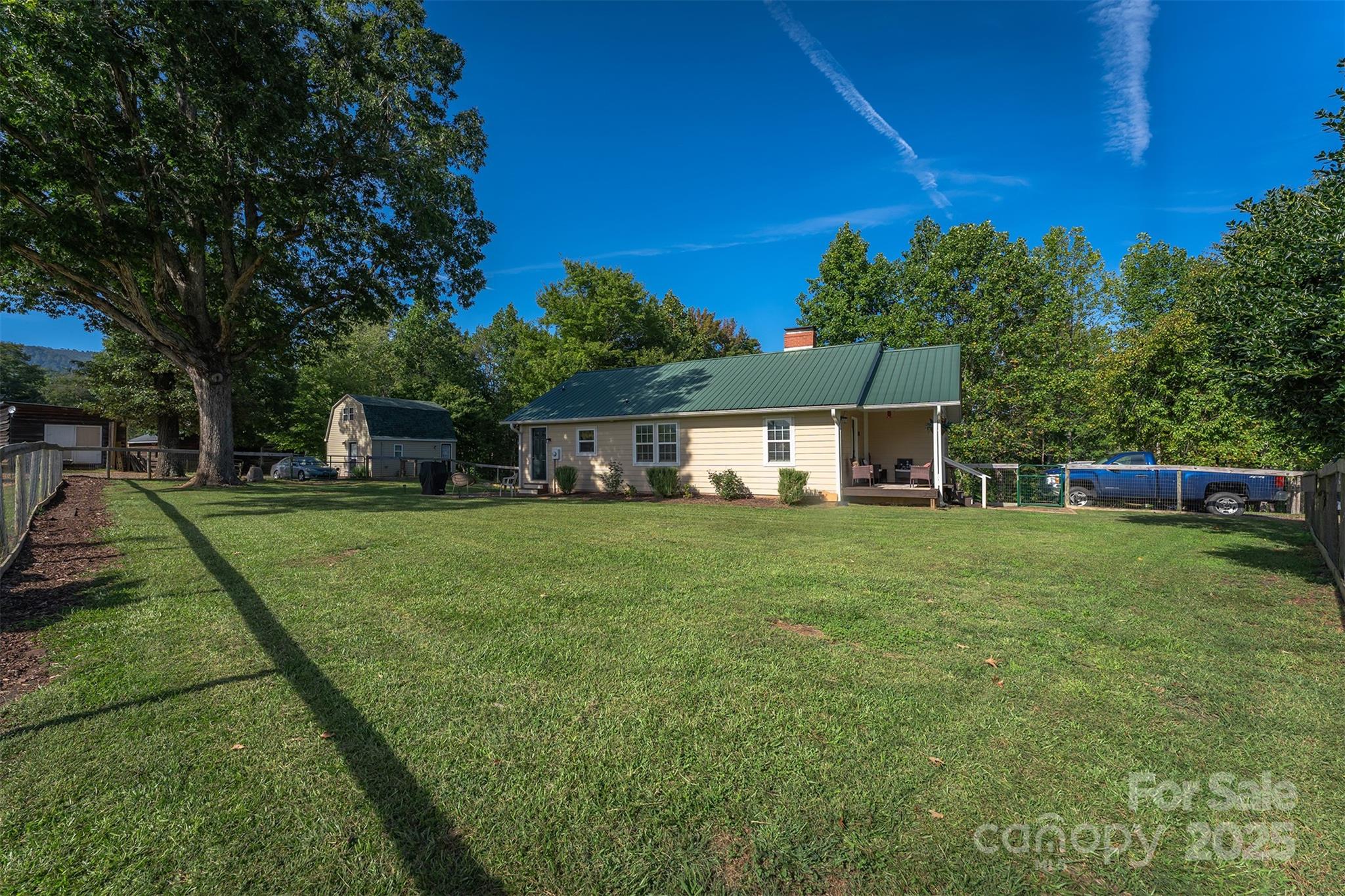 1434 Lake Adger Road Mill Spring, NC 28756 - Photo 25 of 48 a front view of a house with a garden