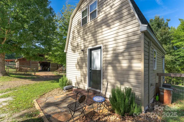 a living room with furniture a flat screen tv and kitchen view
