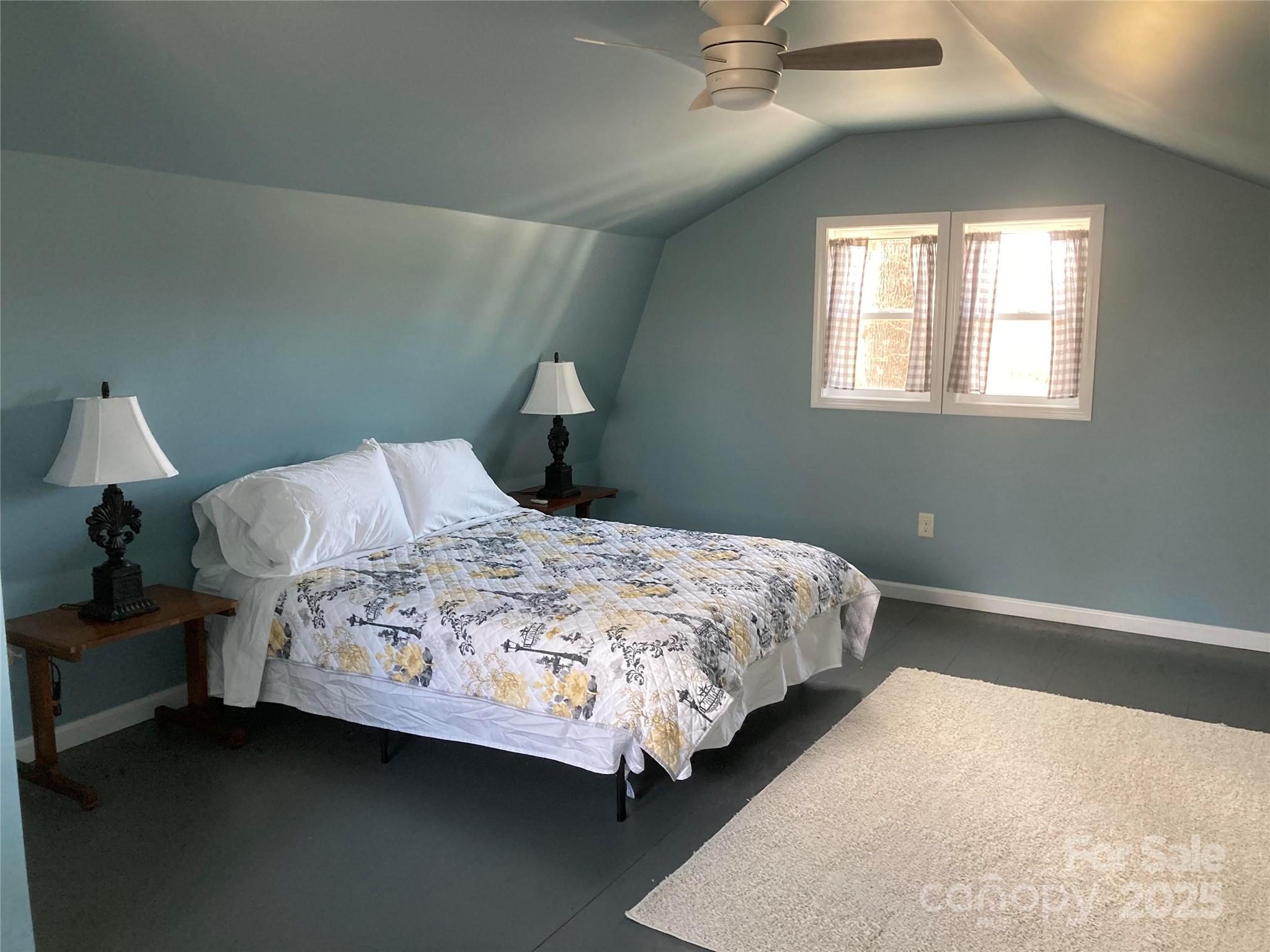 1434 Lake Adger Road Mill Spring, NC 28756 - Photo 30 of 48 a bedroom with a bed lamp and window