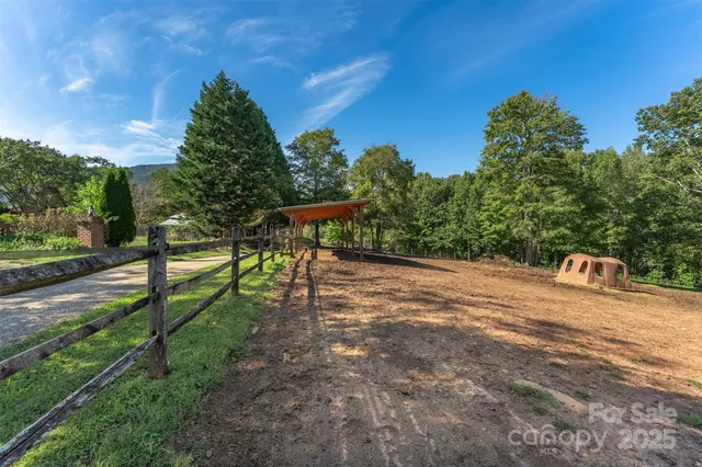 a view of a park with wooden fence