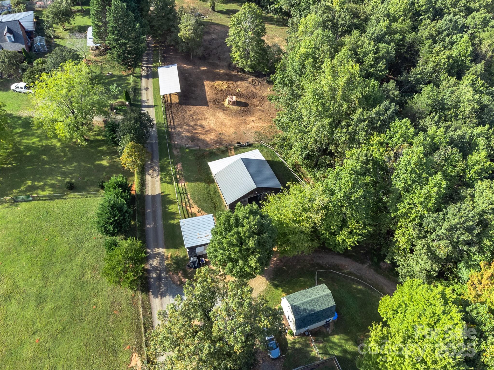 1434 Lake Adger Road Mill Spring, NC 28756 - Photo 42 of 48 an aerial view of a house with a yard