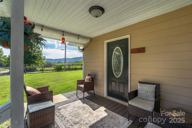a bench sitting in backside of a house with a yard