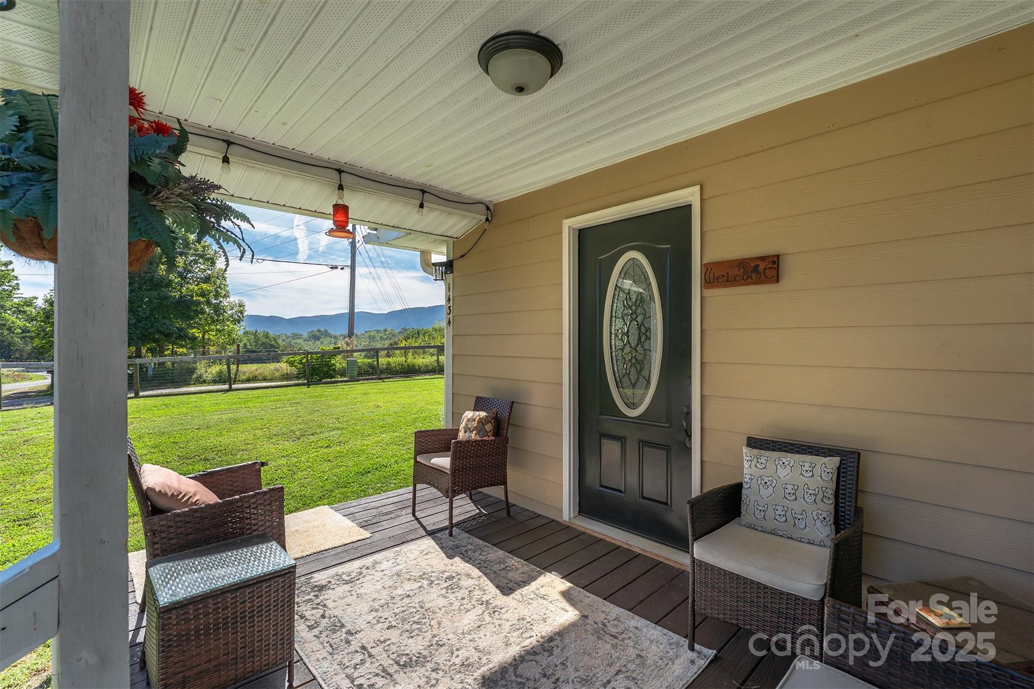 1434 Lake Adger Road Mill Spring, NC 28756 - Photo 6 of 48 a bench sitting in backside of a house with a yard