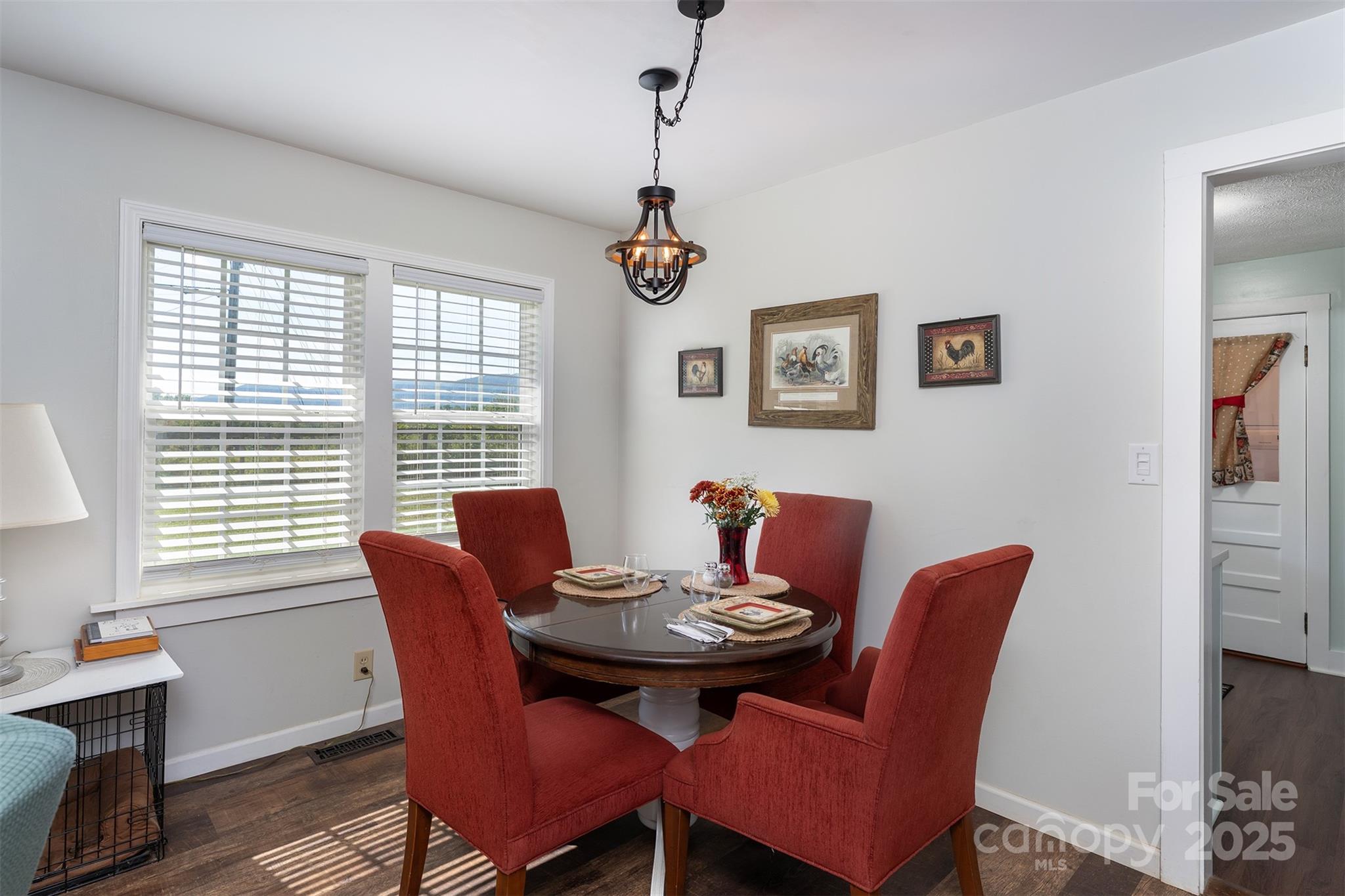 1434 Lake Adger Road Mill Spring, NC 28756 - Photo 9 of 48 a view of a dining room with furniture window and wooden floor