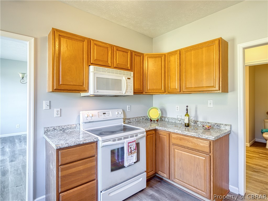 921 Buckley Hall Road Dutton, VA 23050 - Photo 18 of 42 a kitchen with stainless steel appliances granite countertop a sink stove and microwave
