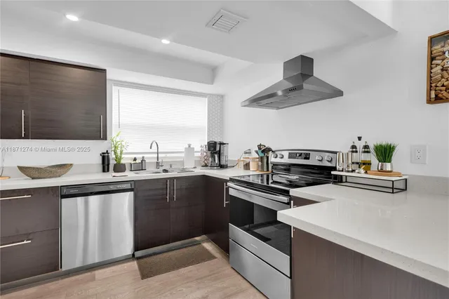 a kitchen with a sink stainless steel appliances and cabinets