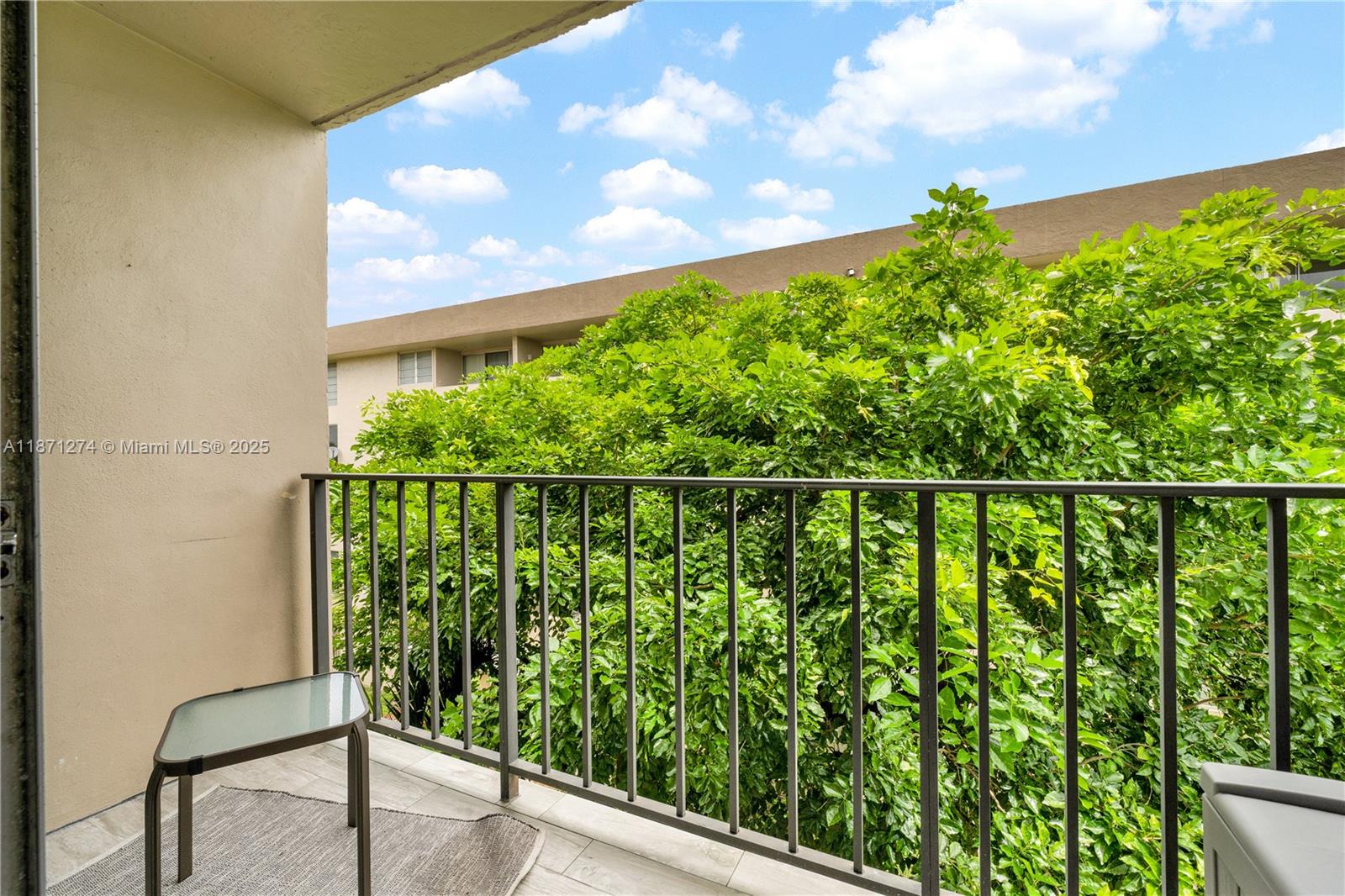 830 Northwest 87th Avenue, Unit 406 Miami, FL 33172 - Photo 18 of 40 a balcony with a yard