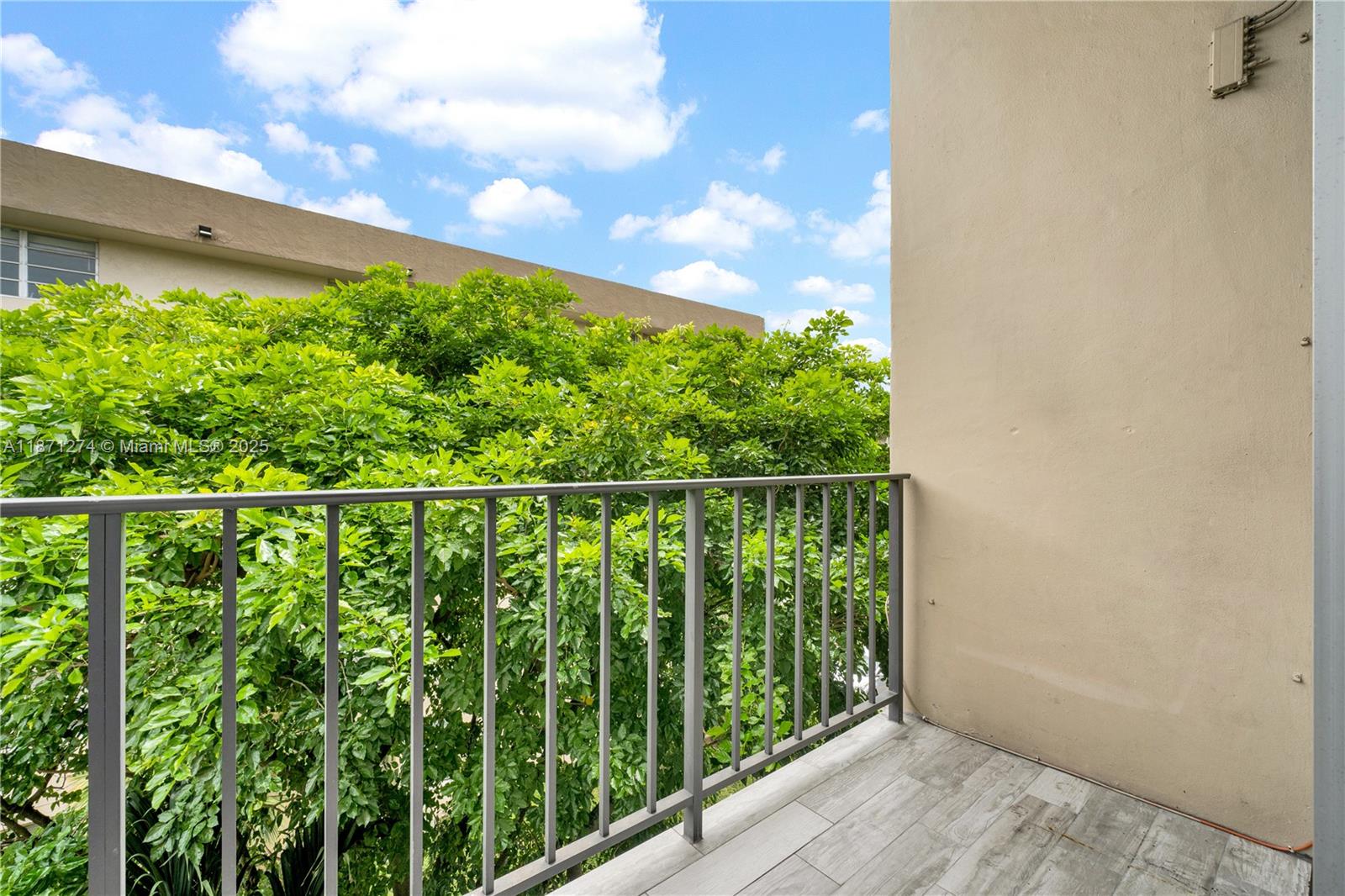 830 Northwest 87th Avenue, Unit 406 Miami, FL 33172 - Photo 20 of 40 a balcony with trees in front of it