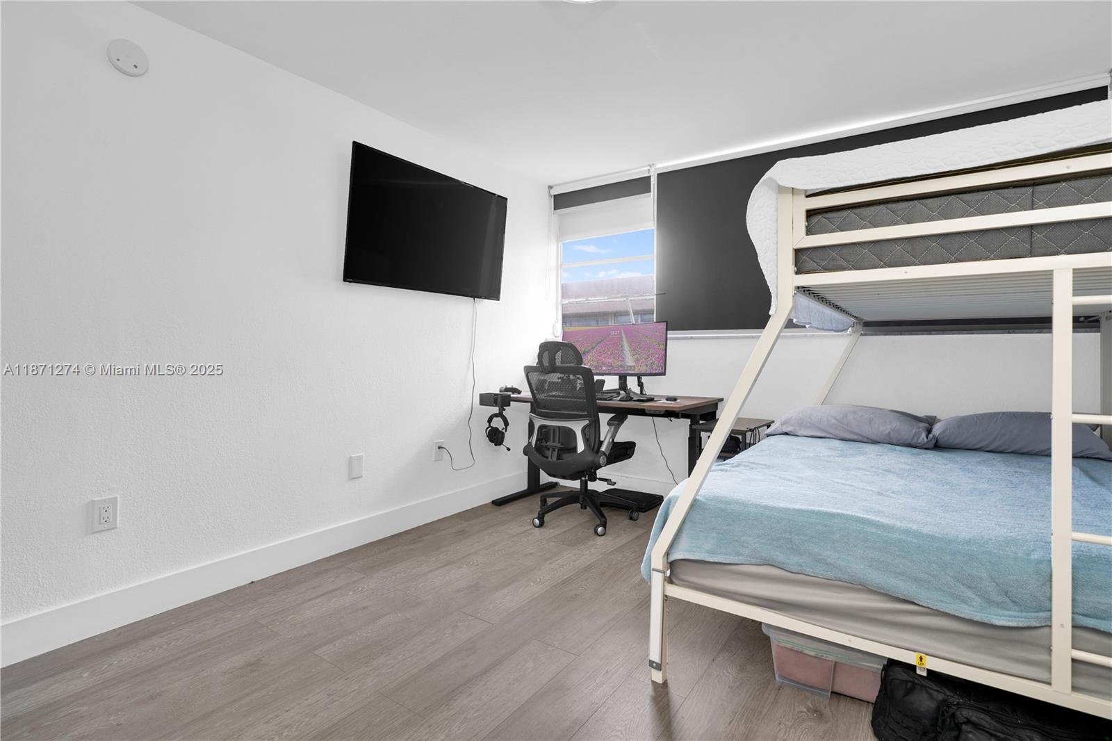 830 Northwest 87th Avenue, Unit 406 Miami, FL 33172 - Photo 22 of 40 a bedroom with a bed and a flat screen tv