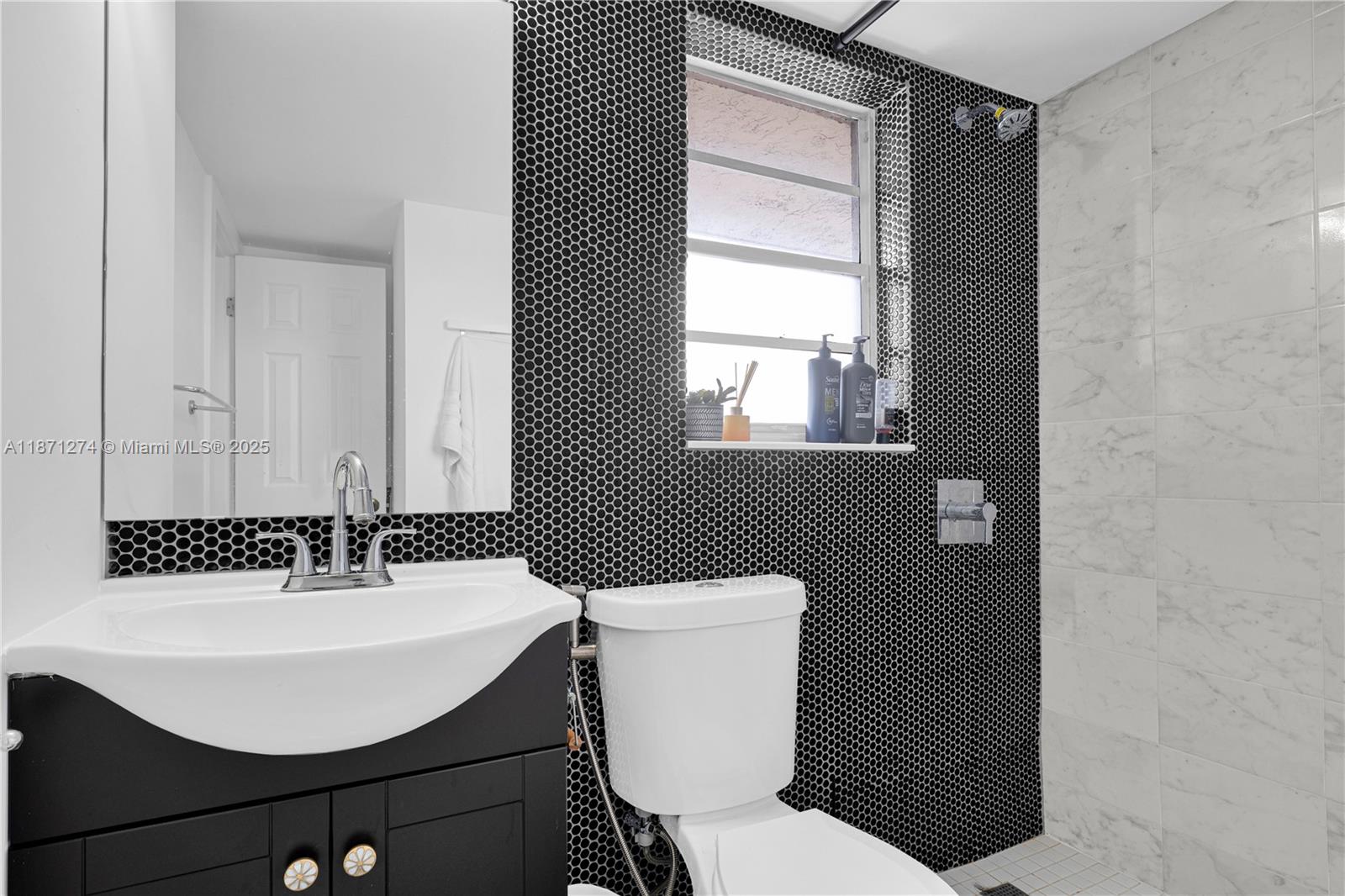 830 Northwest 87th Avenue, Unit 406 Miami, FL 33172 - Photo 24 of 40 a bathroom with a sink toilet and a mirror