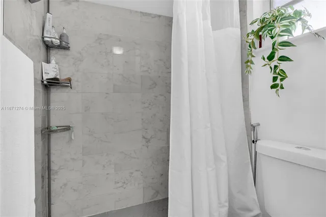 a view of a livingroom with furniture and a floor to ceiling window