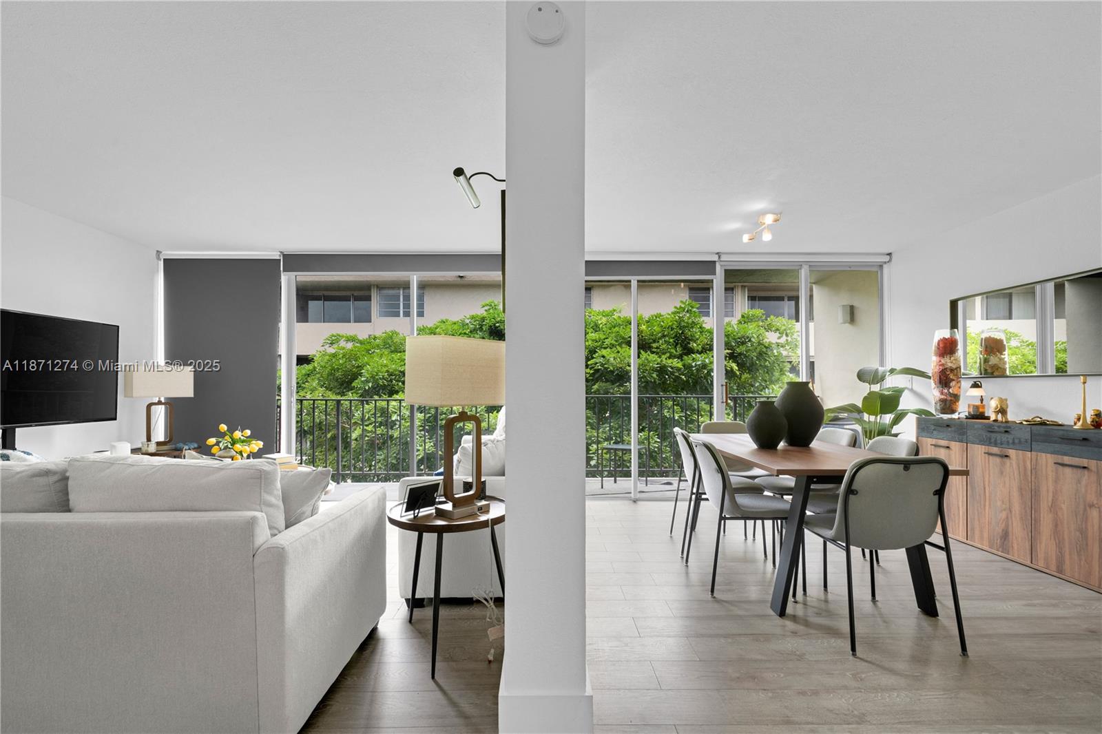 830 Northwest 87th Avenue, Unit 406 Miami, FL 33172 - Photo 3 of 40 a living room with furniture and a large window