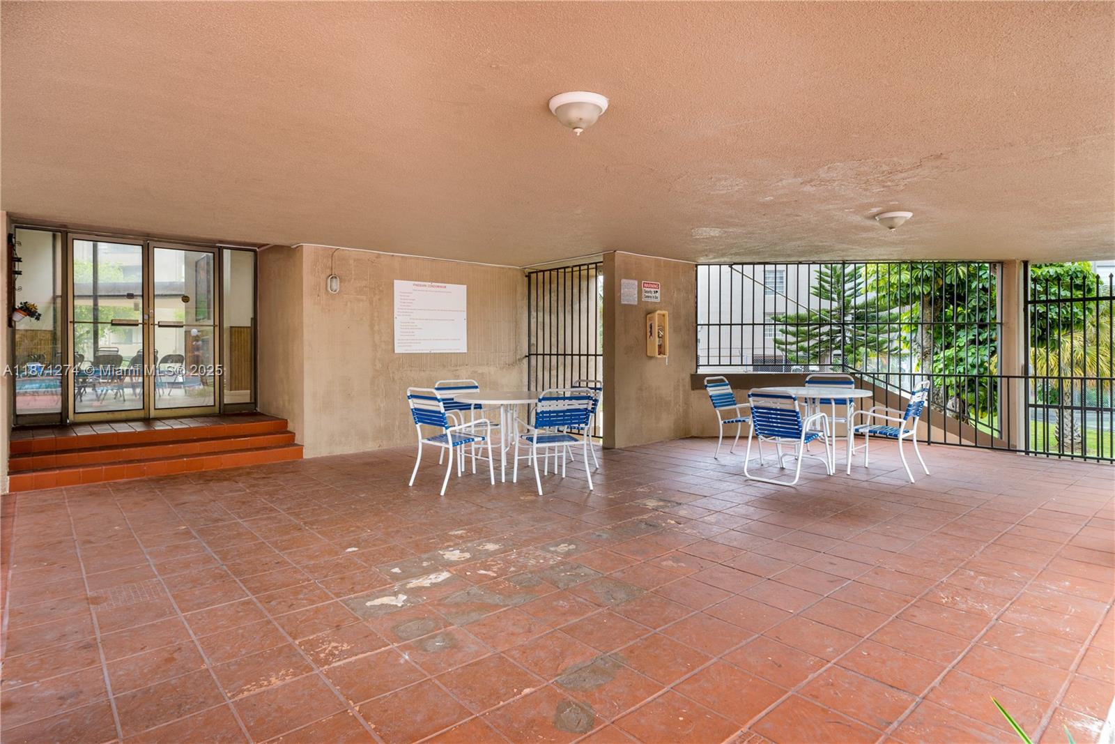 830 Northwest 87th Avenue, Unit 406 Miami, FL 33172 - Photo 37 of 40 a dining room with furniture and a floor to ceiling window