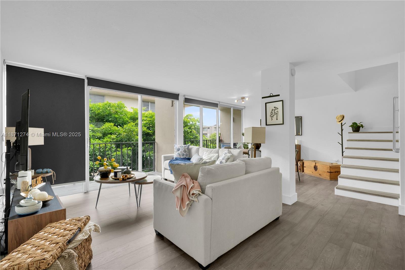 830 Northwest 87th Avenue, Unit 406 Miami, FL 33172 - Photo 5 of 40 a living room with furniture and a large window