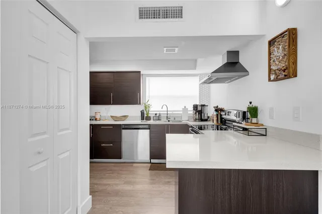 a kitchen with a sink and white cabinets
