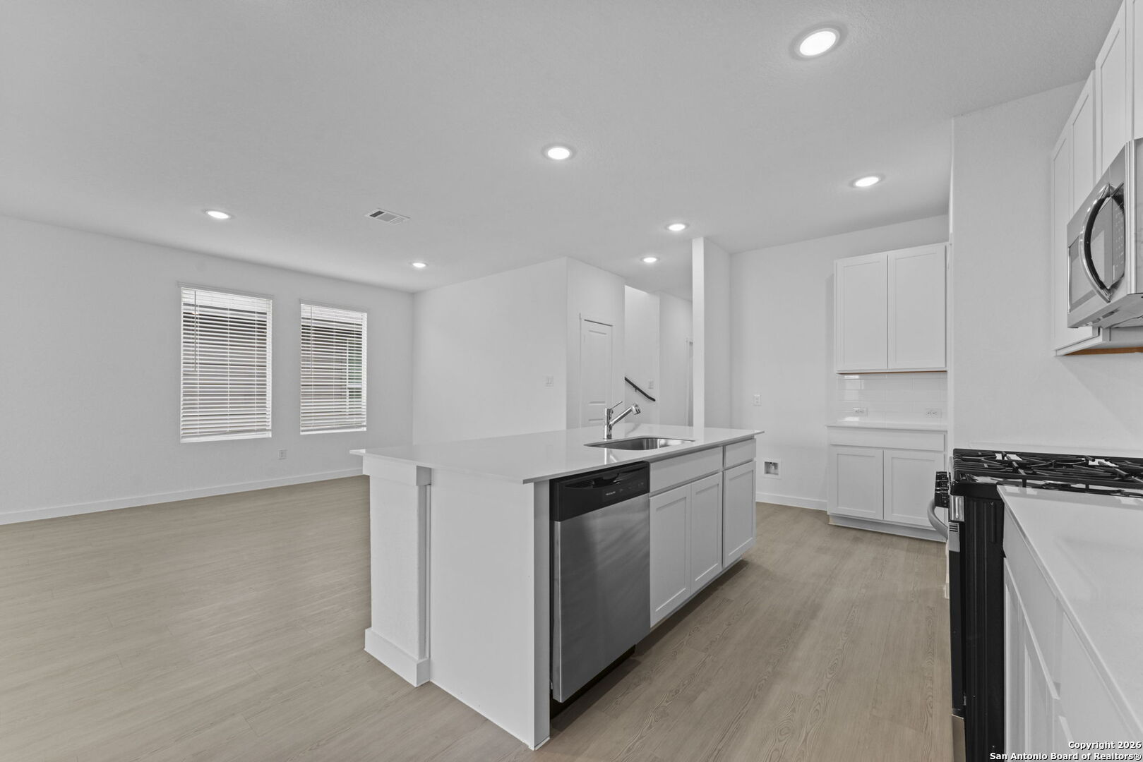1875 Nuthatch Ridge New Braunfels, TX 78130 - Photo 12 of 34 a large kitchen with kitchen island a sink stainless steel appliances and cabinets