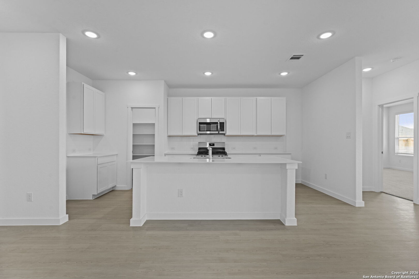 1875 Nuthatch Ridge New Braunfels, TX 78130 - Photo 13 of 34 a view of kitchen center refrigerator and white cabinets