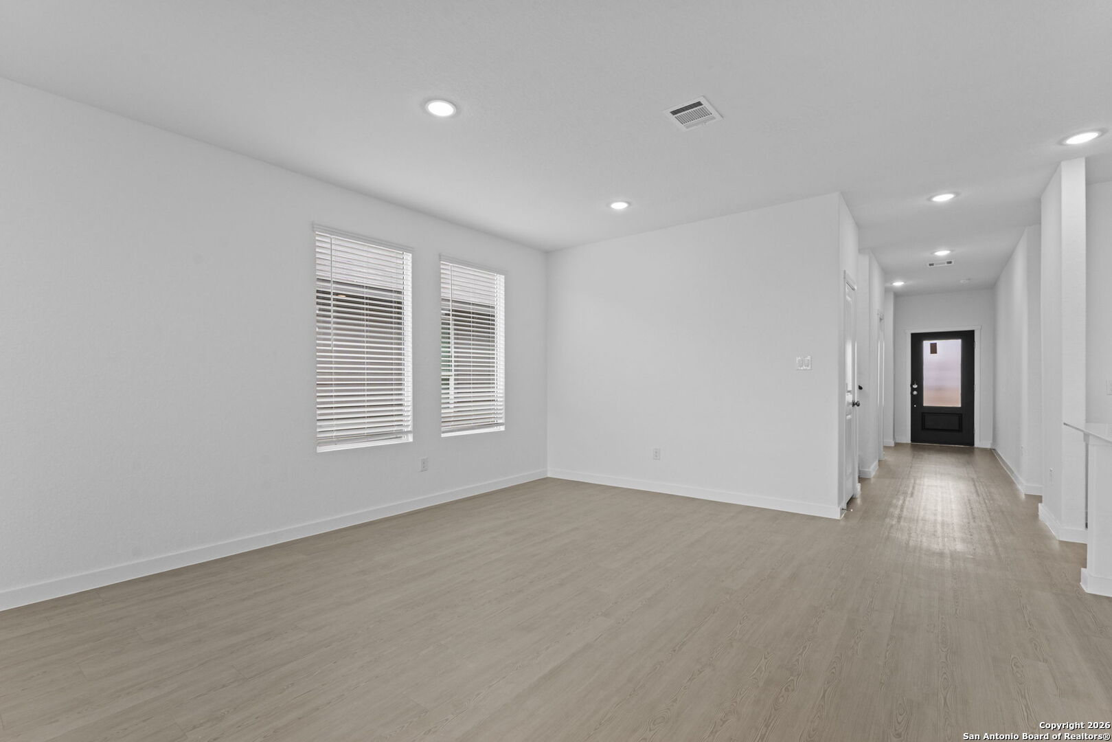 1875 Nuthatch Ridge New Braunfels, TX 78130 - Photo 14 of 34 a view of empty room with wooden floor and windows