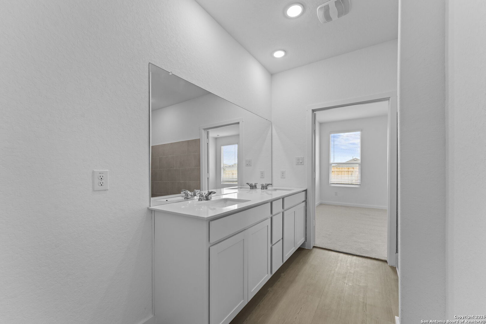 1875 Nuthatch Ridge New Braunfels, TX 78130 - Photo 20 of 34 a bathroom with a sink a light fixture and a mirror