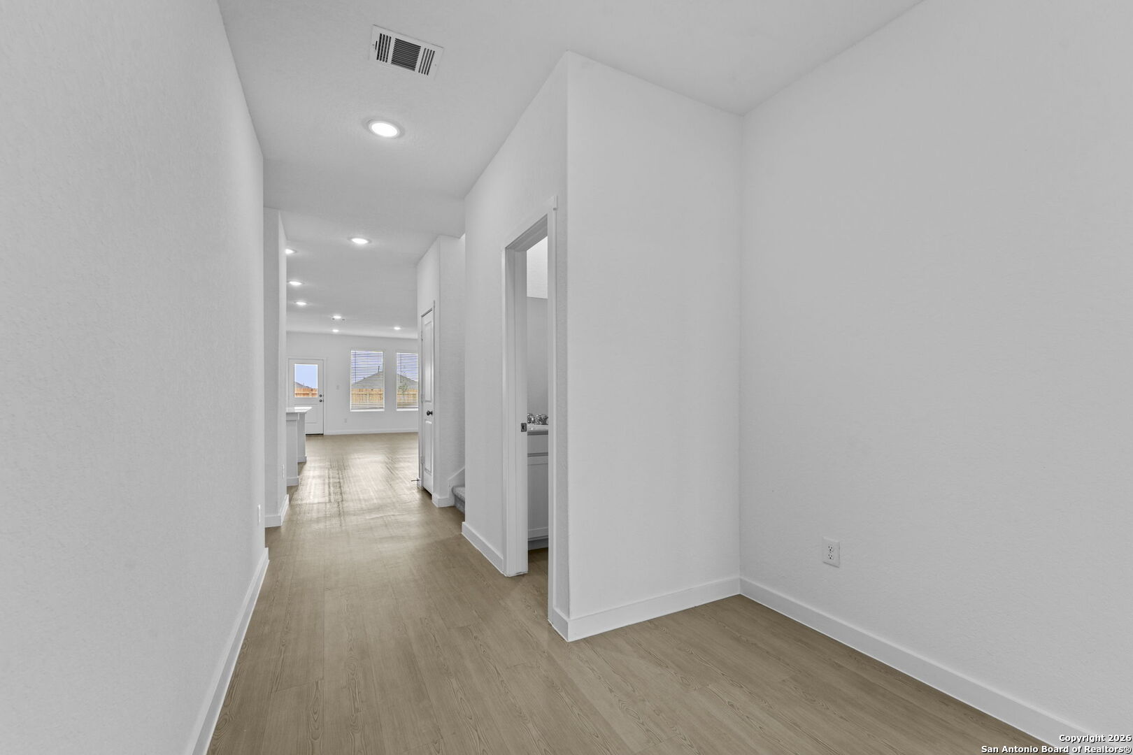 1875 Nuthatch Ridge New Braunfels, TX 78130 - Photo 3 of 34 a view of a hallway with wooden floor