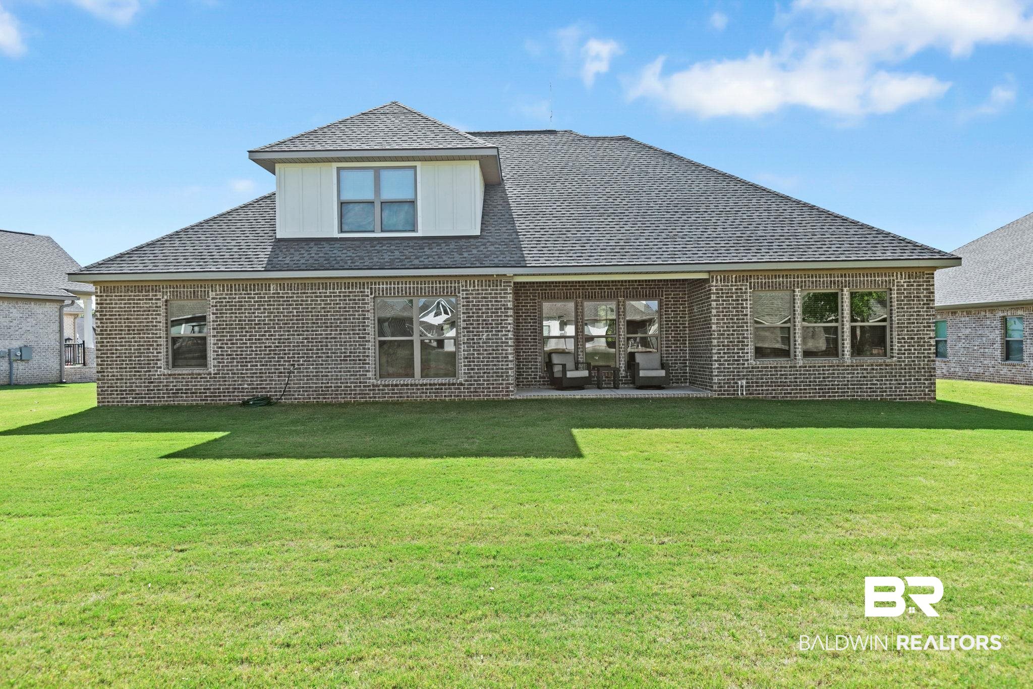 12132 Exbury Way Daphne, AL 36527 - Photo 34 of 47 Back of house with a lawn, roof with shingles, a patio area, and brick siding