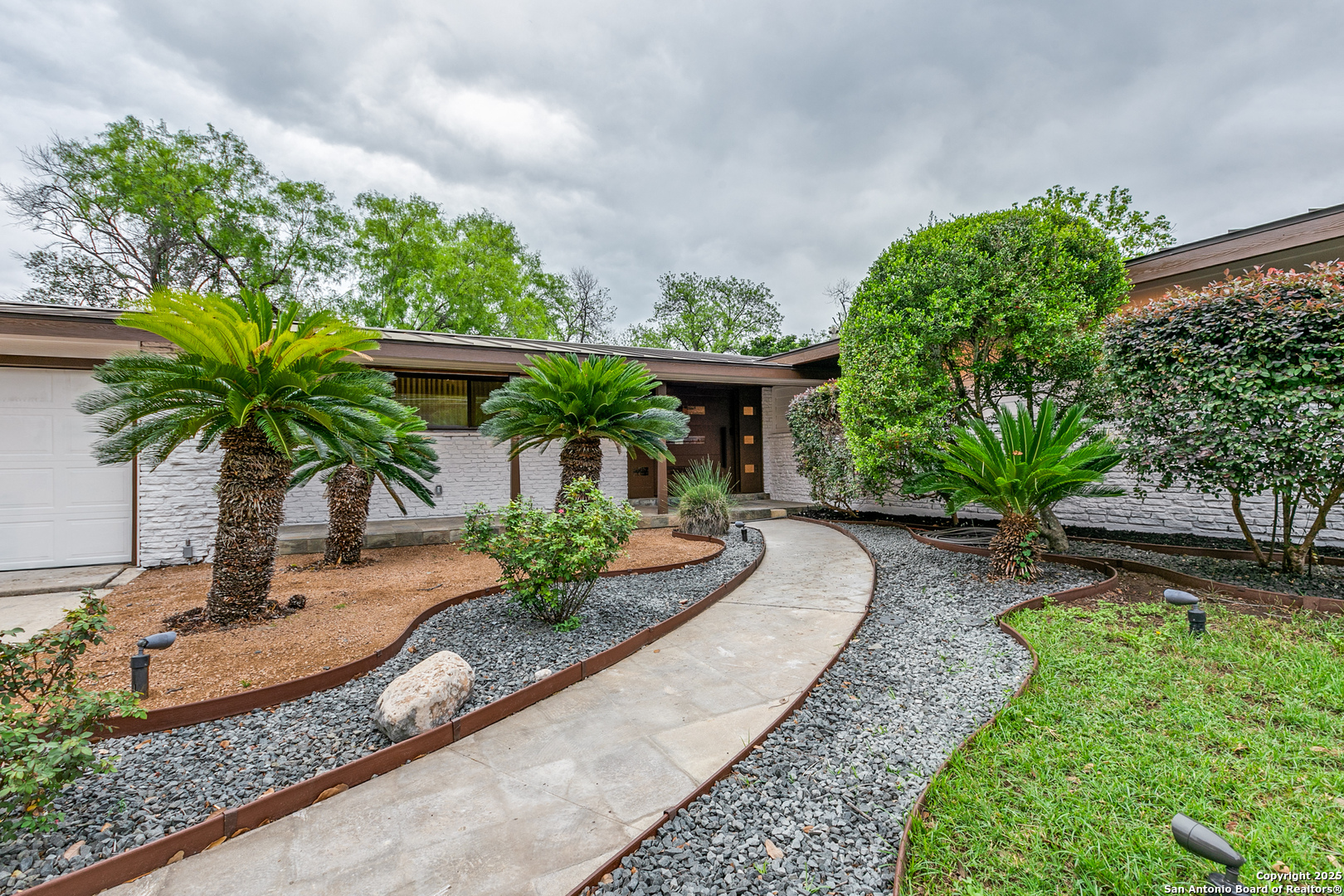 a front view of a house with garden