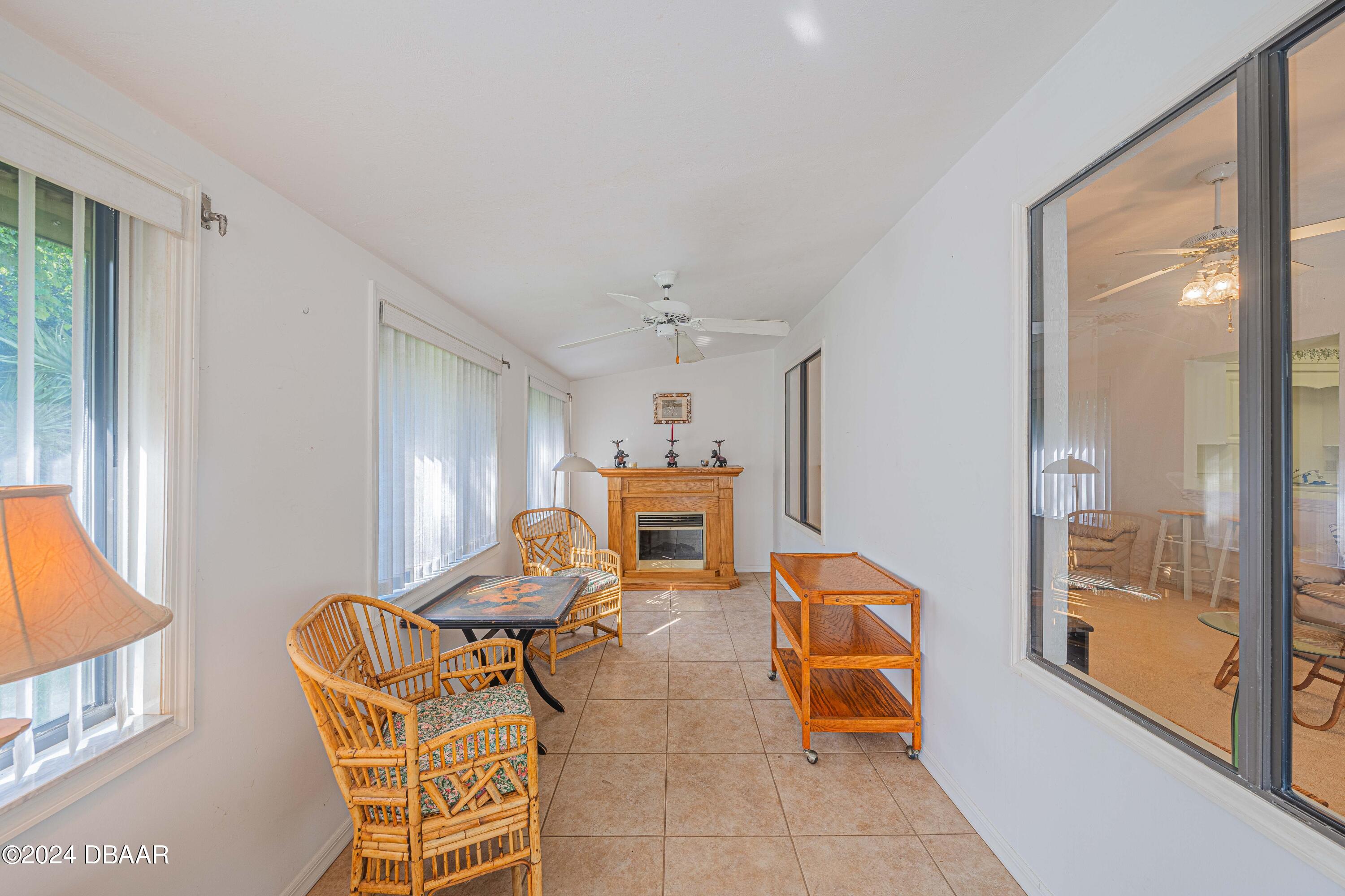 42 Jana Drive Ponce Inlet, FL 32127 - Photo 18 of 34 a living room with furniture and a fireplace
