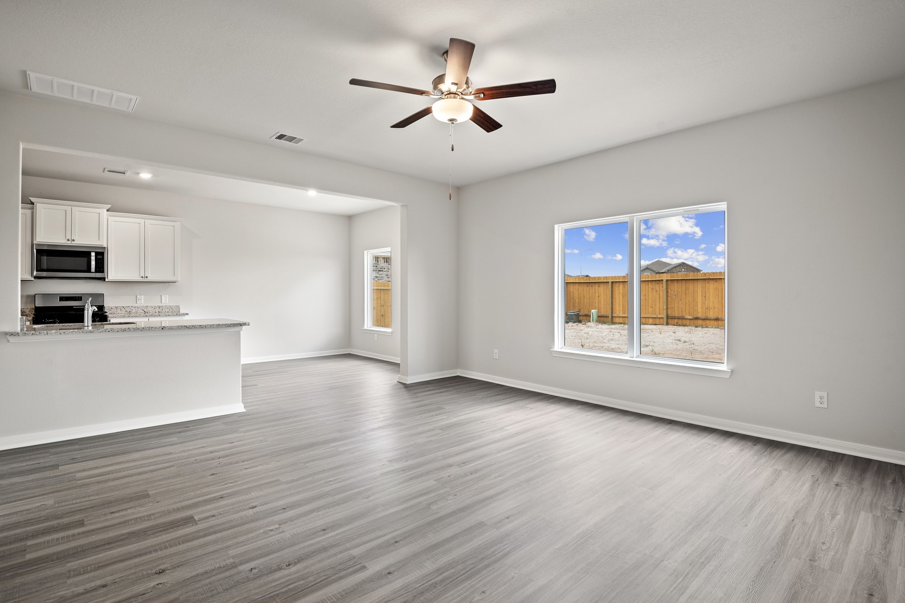 340 Fastboy Lane Waller, TX 77484 - Photo 11 of 22 a view of an empty room with window and wooden floor