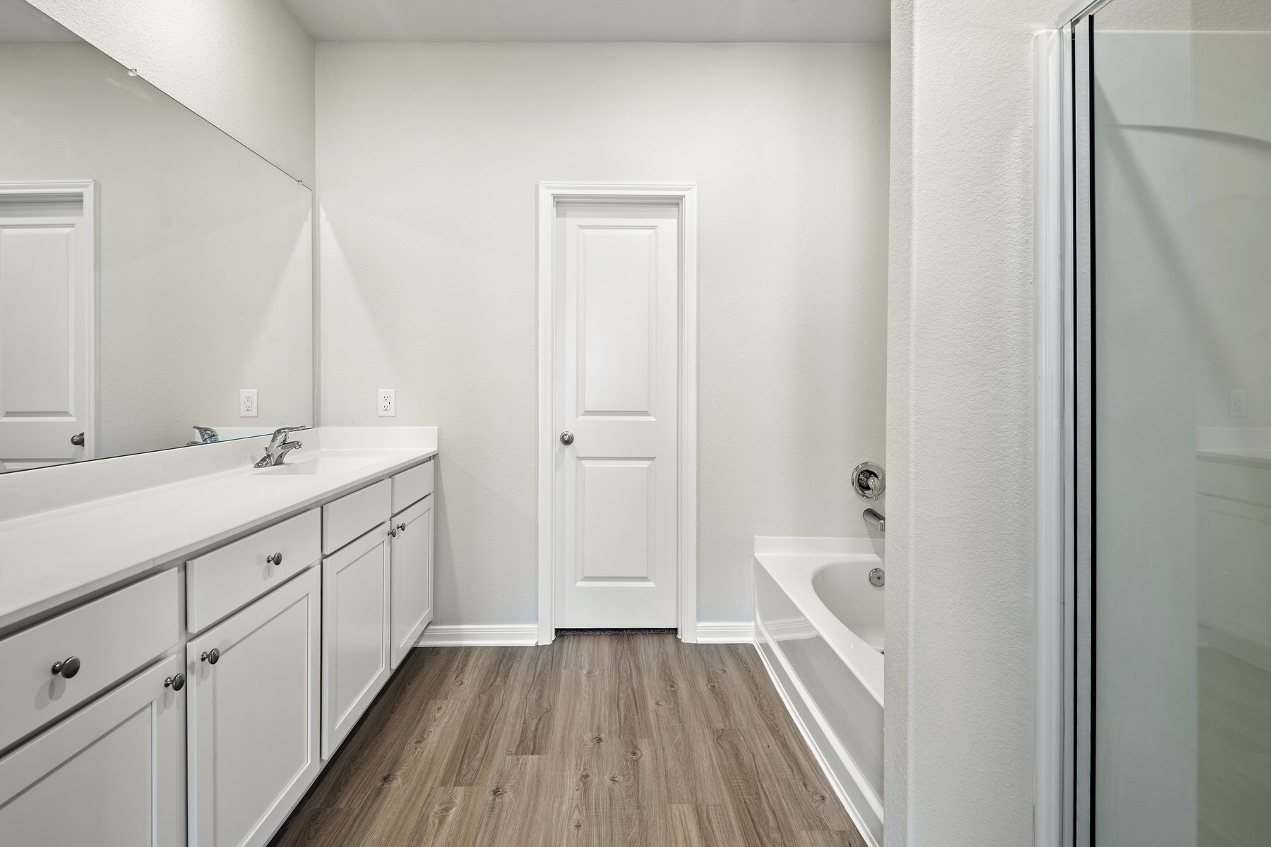 340 Fastboy Lane Waller, TX 77484 - Photo 16 of 22 a bathroom with a sink a mirror and a bathtub