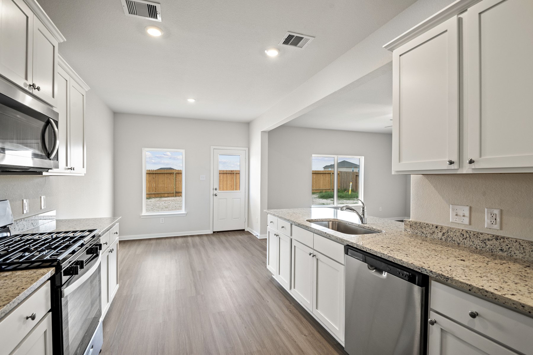 340 Fastboy Lane Waller, TX 77484 - Photo 7 of 22 a kitchen with stainless steel appliances granite countertop a stove a sink and a microwave
