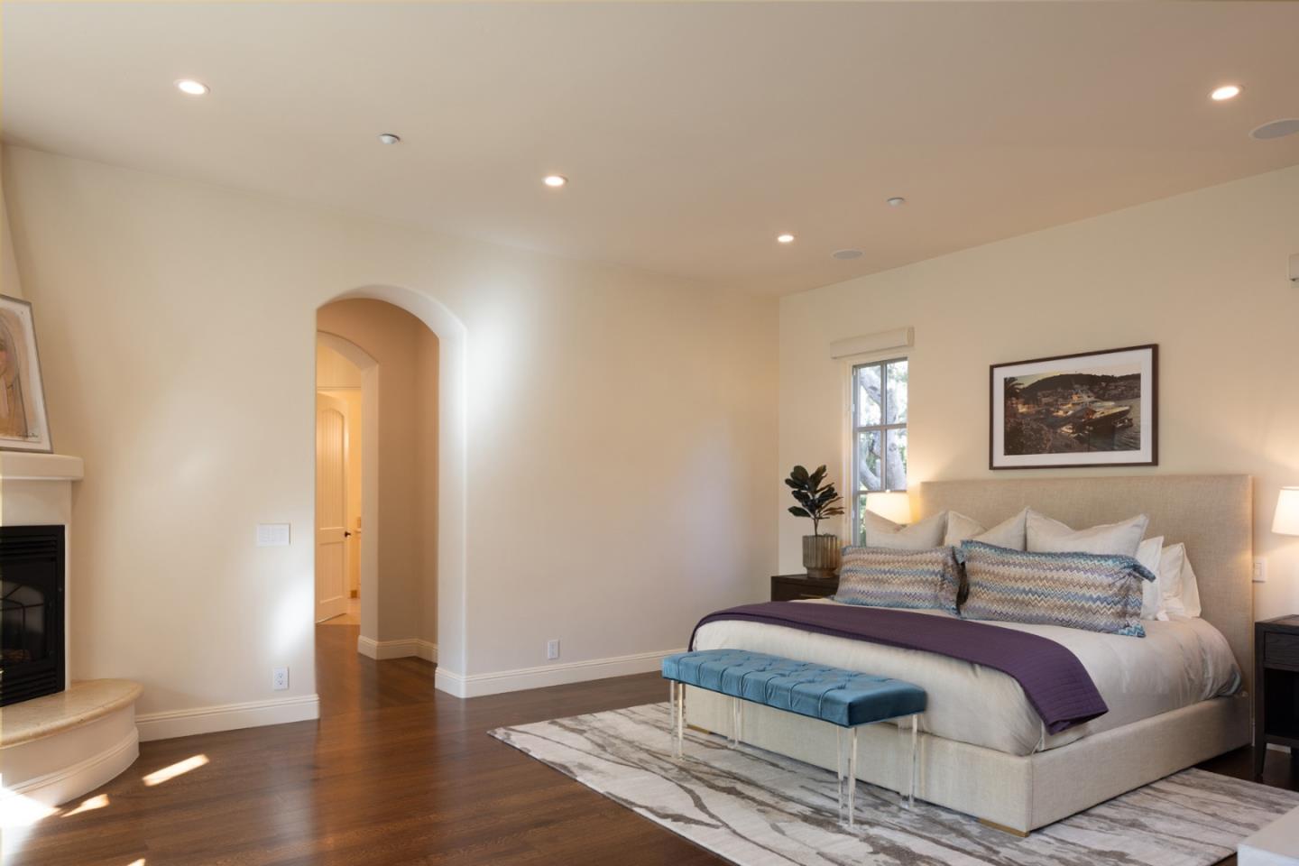 3957 Ronda Road Pebble Beach, CA 93953 - Photo 15 of 26 a spacious bedroom with a bed and wooden floor