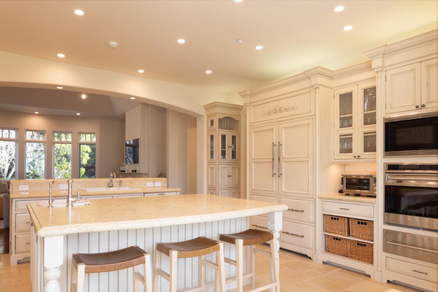 3957 Ronda Road Pebble Beach, CA 93953 - Photo 8 of 26 a kitchen with stainless steel appliances kitchen island granite countertop a stove and a sink