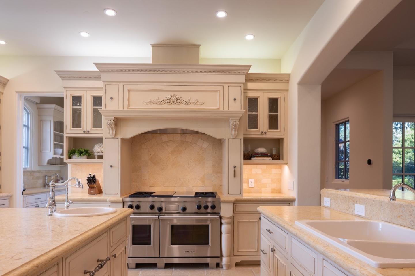 3957 Ronda Road Pebble Beach, CA 93953 - Photo 9 of 26 a kitchen with a stove and a sink