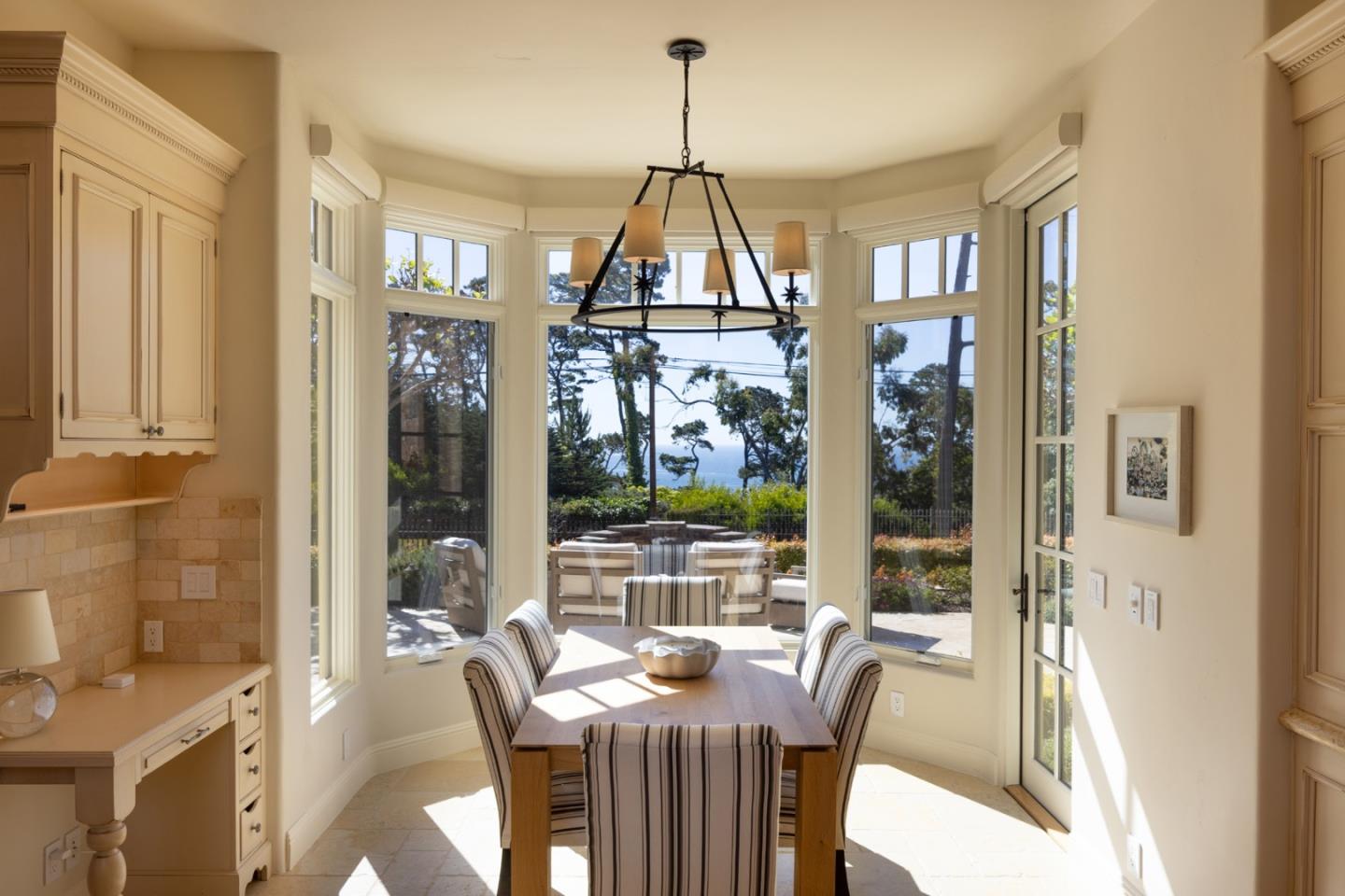 3957 Ronda Road Pebble Beach, CA 93953 - Photo 10 of 26 a dining room with furniture a chandelier and wooden floor
