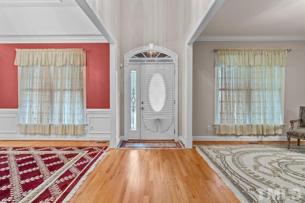 5725 Turner Store Lane Raleigh, NC 27603 - Photo 5 of 30 a view of a bedroom with wooden floor and a window