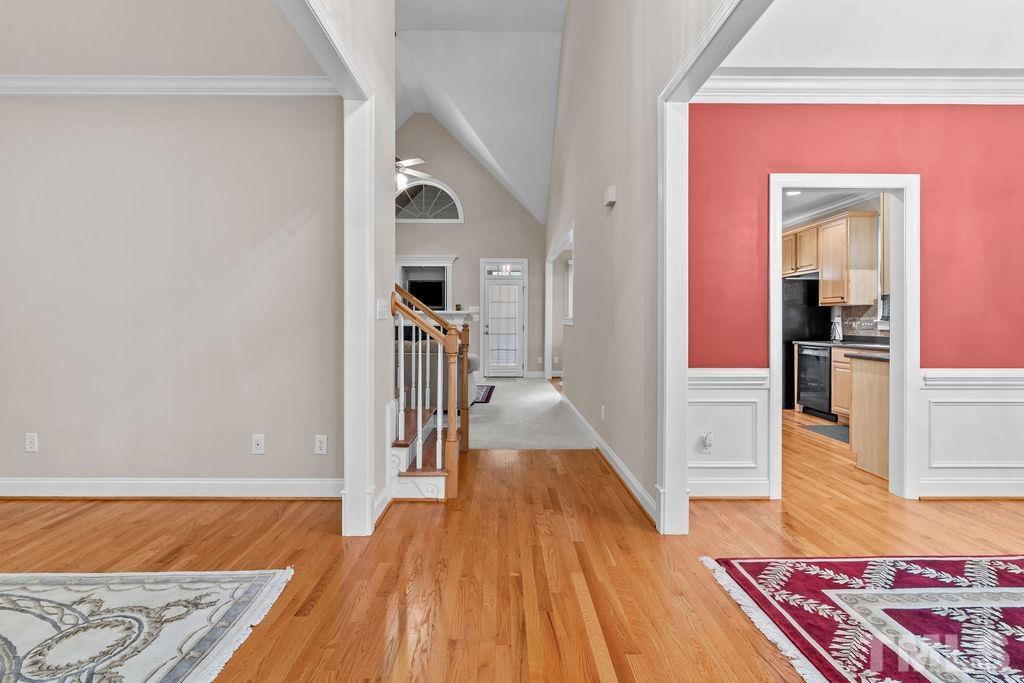 5725 Turner Store Lane Raleigh, NC 27603 - Photo 6 of 30 a view of a hallway with wooden floor and staircase