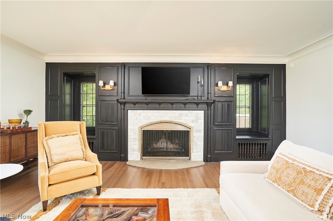 644 Ridgecrest Road Akron, OH 44303 - Photo 11 of 47 Fireplace wall featuring dark paneled millwork with integrated shelving and window seating