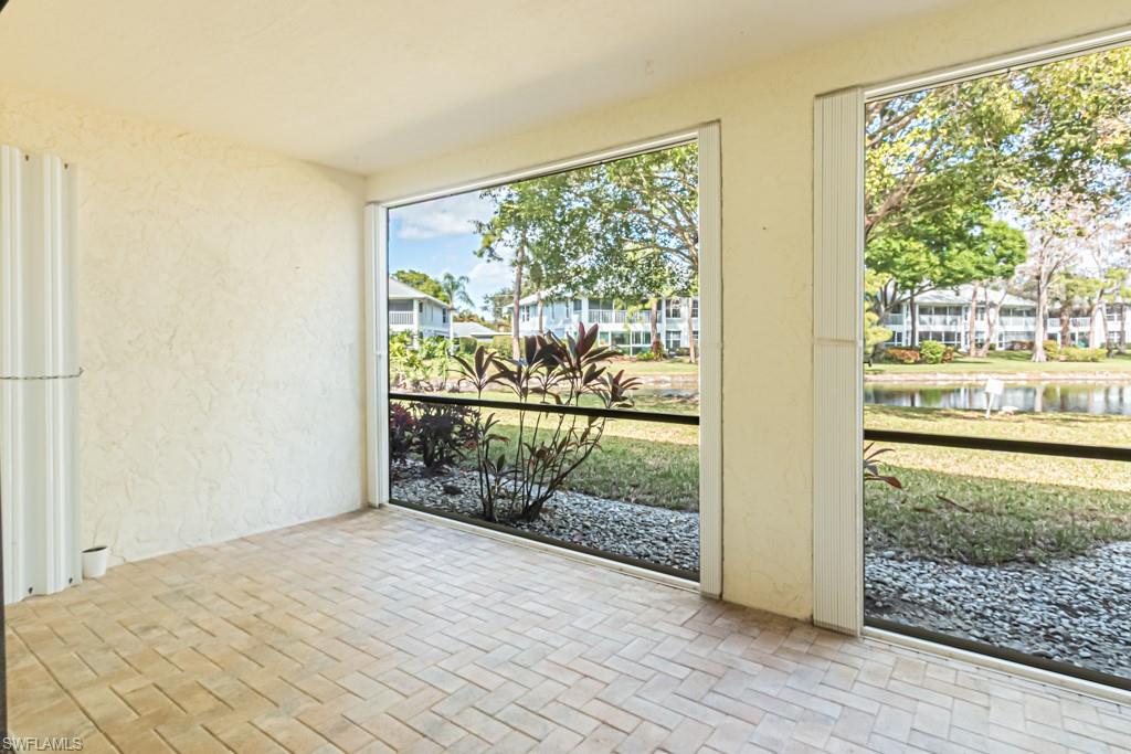 600 Misty Pines Circle, Unit F105 Naples, FL 34105 - Photo 35 of 49 Screened Lanai with lovely lake views