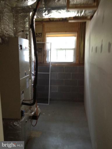 419 Burns Street Ranson, WV 25438 - Photo 5 of 22 a room with water heater and wooden cabinet