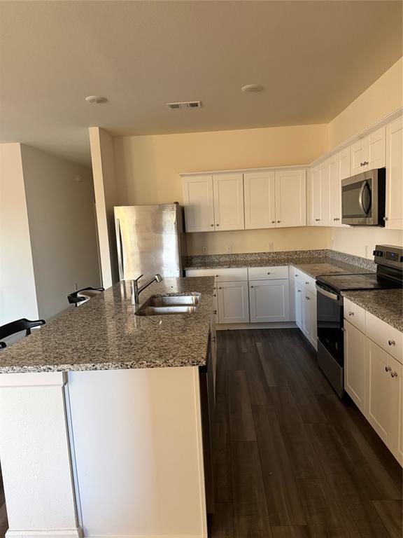 1852 McCree Street Forney, TX 75126 - Photo 16 of 21 a kitchen with stainless steel appliances granite countertop a sink stove and microwave