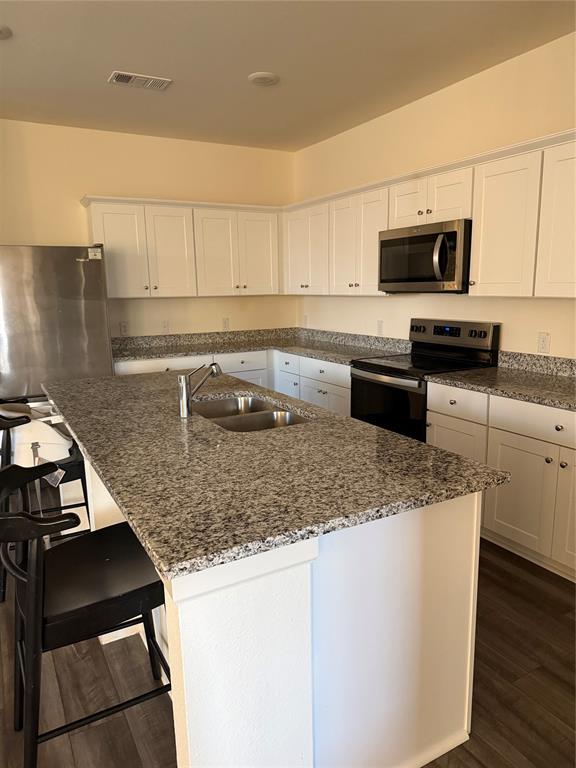1852 McCree Street Forney, TX 75126 - Photo 17 of 21 a kitchen with stainless steel appliances granite countertop a sink stove and microwave