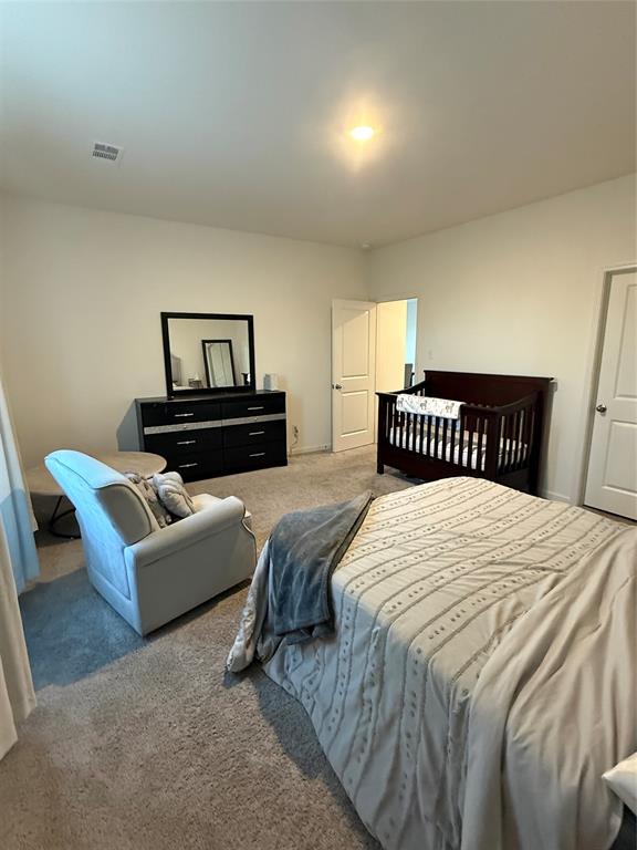 1852 McCree Street Forney, TX 75126 - Photo 5 of 21 a bedroom with a bed and a couch