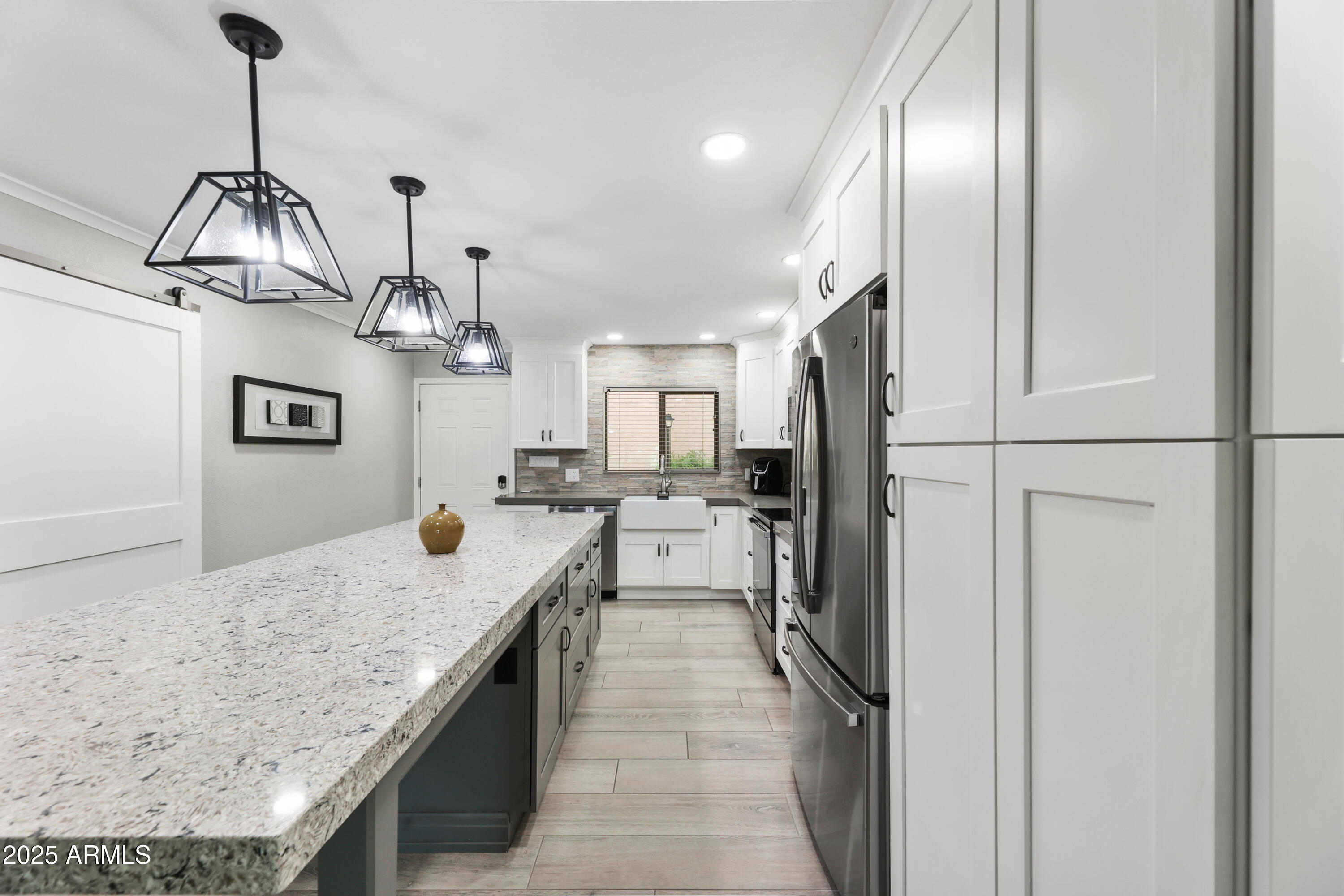 7430 East Chaparral Road, Unit A115 Scottsdale, AZ 85250 - Photo 3 of 15 a kitchen with stainless steel appliances granite countertop cabinets a sink and a wooden floor