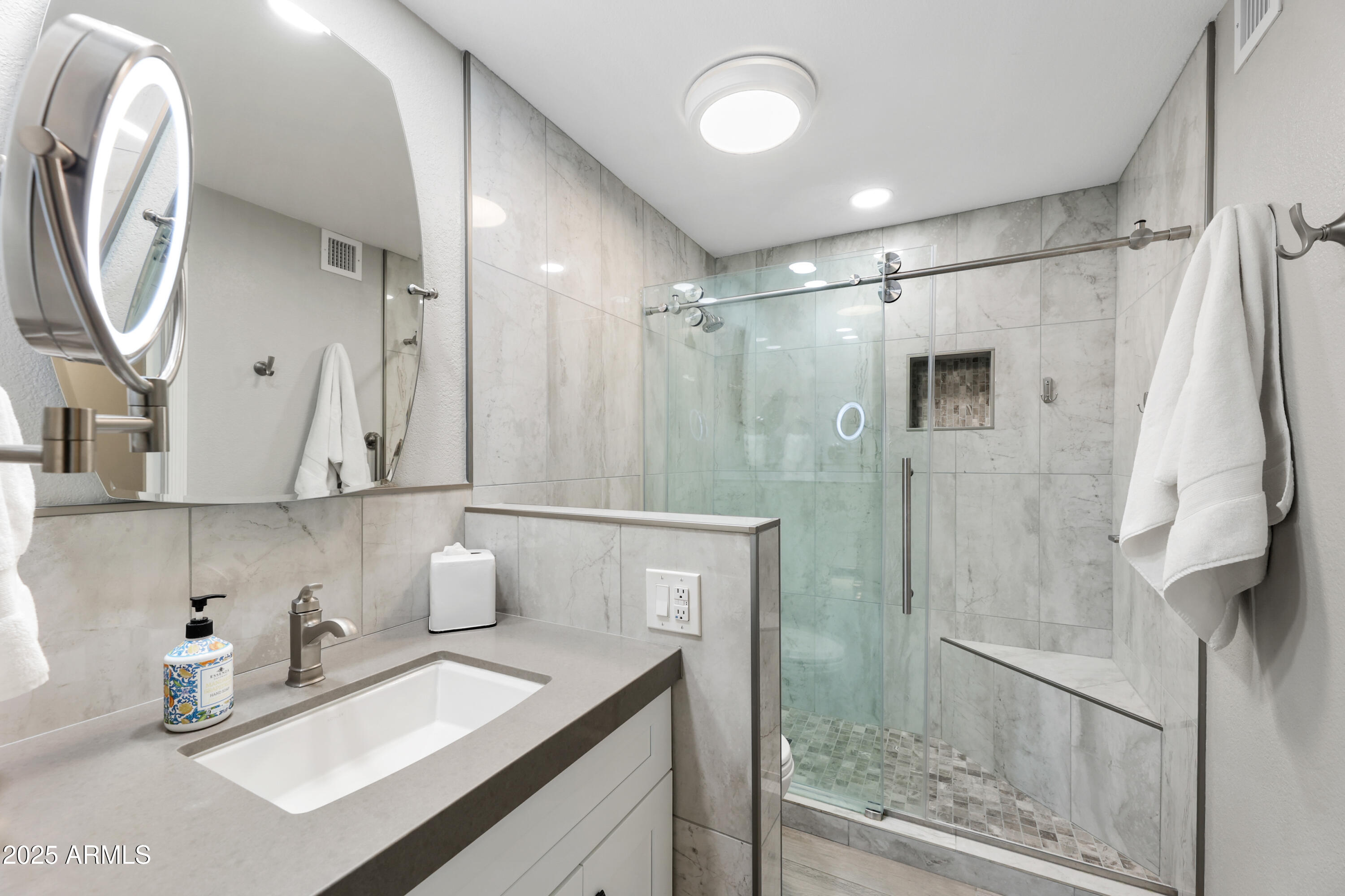 7430 East Chaparral Road, Unit A115 Scottsdale, AZ 85250 - Photo 8 of 15 a bathroom with a sink and a mirror