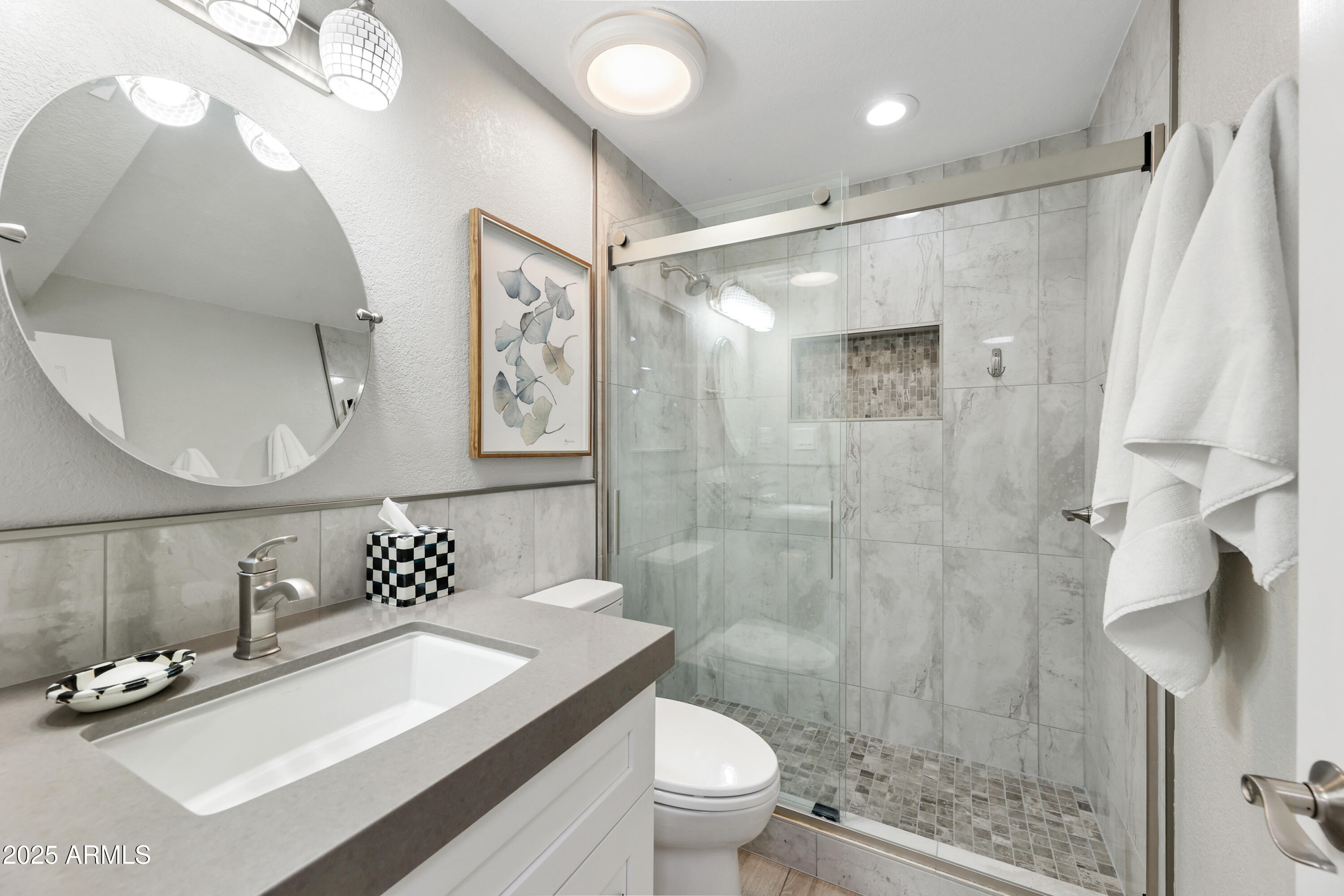7430 East Chaparral Road, Unit A115 Scottsdale, AZ 85250 - Photo 10 of 15 a bathroom with a sink toilet a mirror and shower