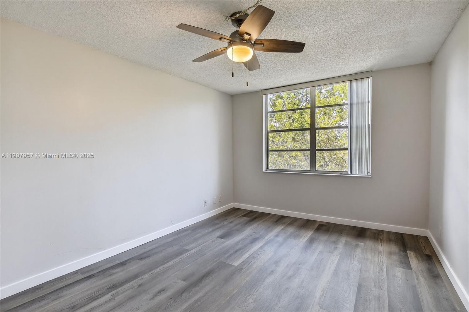 6500 Cypress Road, Unit 410 Plantation, FL 33317 - Photo 13 of 33 wooden floor in an empty room with a window