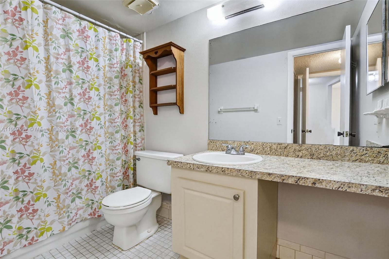 6500 Cypress Road, Unit 410 Plantation, FL 33317 - Photo 17 of 33 a bathroom with a granite countertop toilet sink and mirror