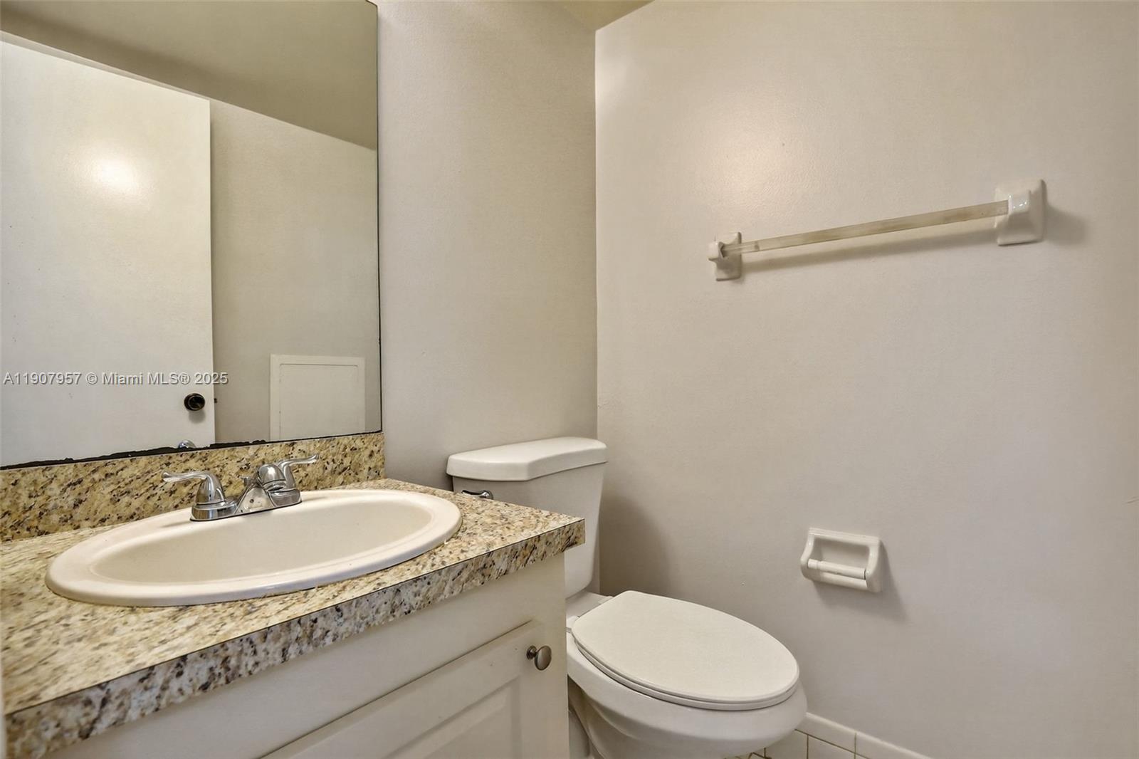 6500 Cypress Road, Unit 410 Plantation, FL 33317 - Photo 19 of 33 a bathroom with a sink toilet and a mirror