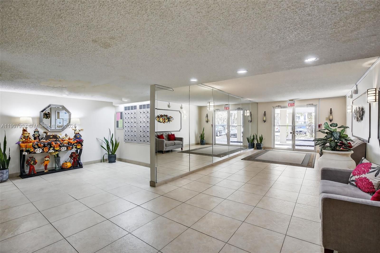 6500 Cypress Road, Unit 410 Plantation, FL 33317 - Photo 24 of 33 a lobby with furniture and cars