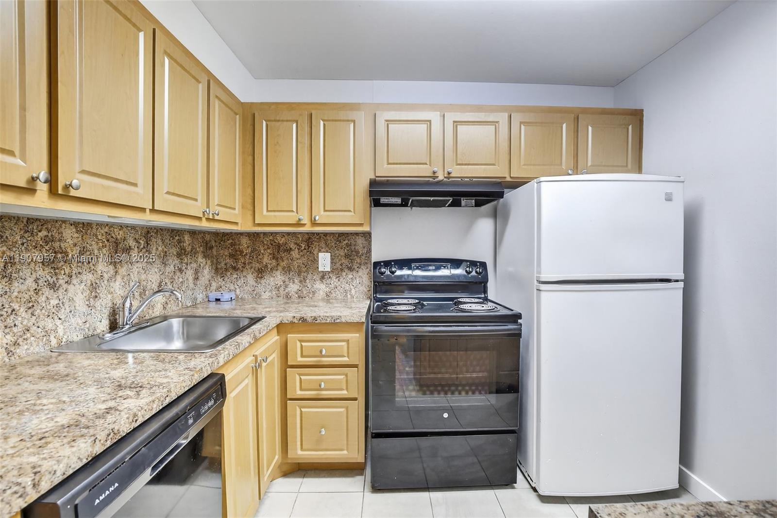 6500 Cypress Road, Unit 410 Plantation, FL 33317 - Photo 4 of 33 a kitchen with a refrigerator sink and cabinets